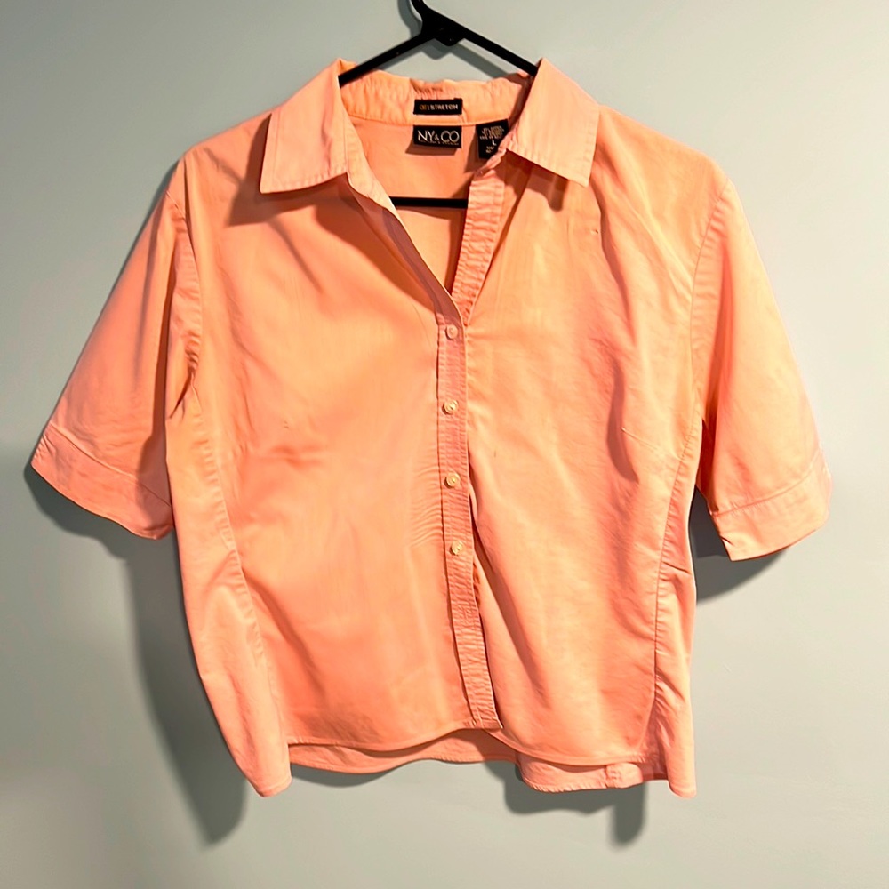 Pink button down shirt.
